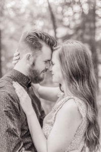 black and white photo of couple in forest