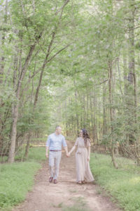 couple walking in the forest for their engagement photoshoot