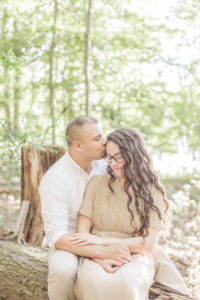 fiance's sitting on a log for their engagement photoshoot