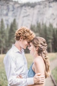 Couple, Man embraces Woman he loves in Yosemite California 