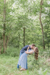 Couple dip kissing in the forest