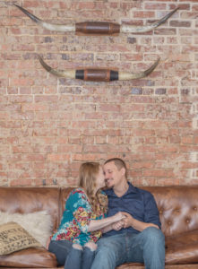 Engagement Photoshoot couple kissing on couch