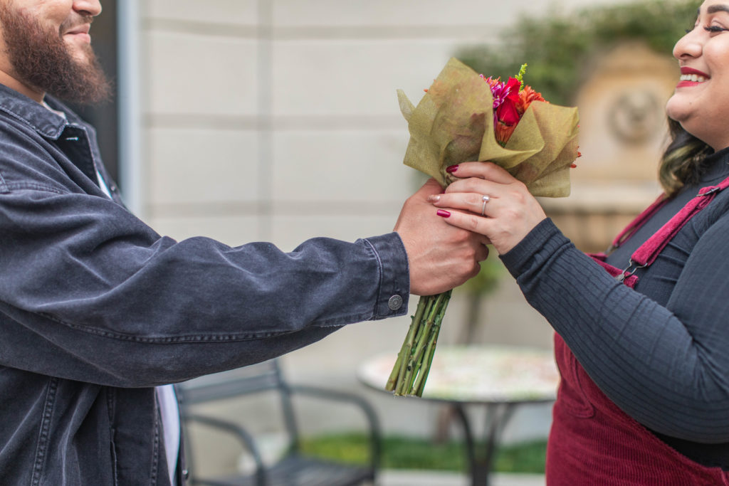 Man giving flowers to his fiance