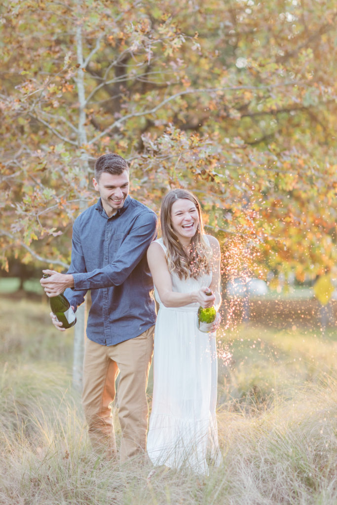 couple celebrates engagement with champagne
