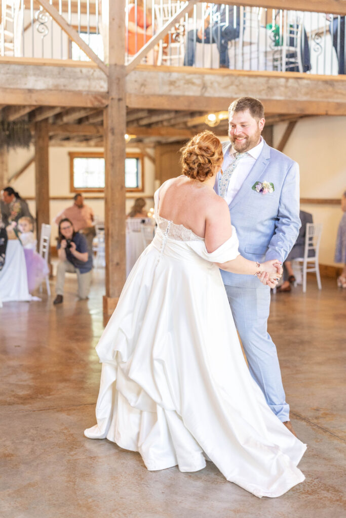 Couple dances together in Lavender Oaks Farm Reception space