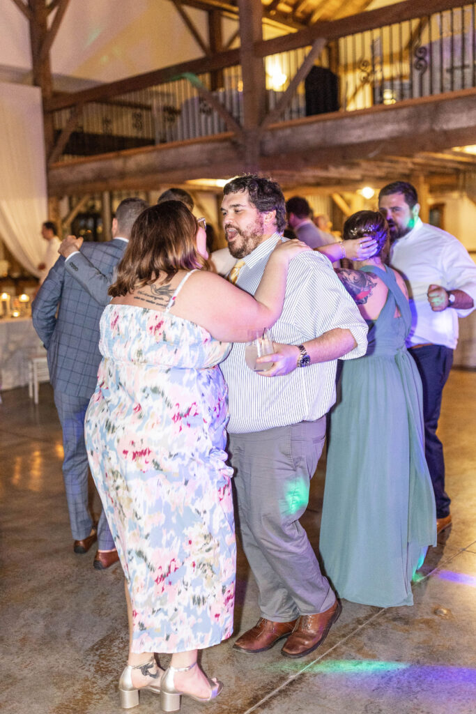 Wedding guests dance in Lavender Oaks Farms main dance floor