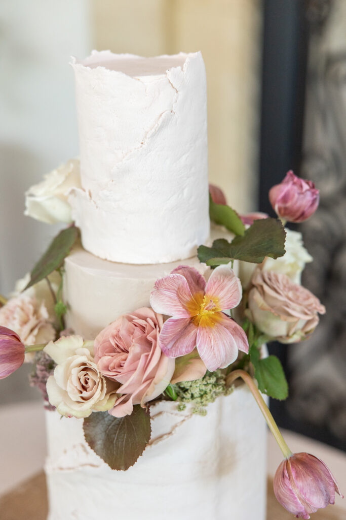 wedding cake with rough edges and flowers
